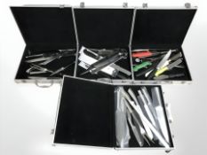 Four aluminium cases containing various culinary knives.