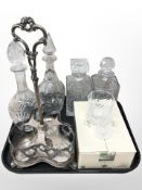 An EPNS bottle stand, four various decanters, set of six Cristal D'Arques liqueur tumblers.