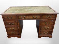 An early 20th century mahogany twin pedestal nine drawer writing desk,