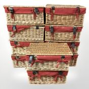Ten wicker picnic hampers.