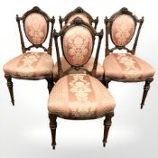 A set of four Victorian carved walnut dining chairs.