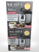 Two instant pot multi use pressure cookers, boxed.