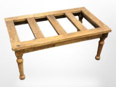 An early 20th century stained pine luggage stand, width 76 cm.