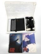 A Sinclair ZX 81 with lead and instructions in polystyrene packaging,