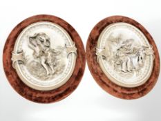 A pair of early 20th century continental porcelain figural wall plaques in velvet frames,