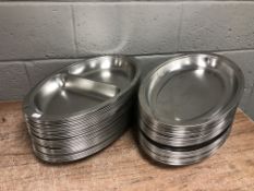 A large quantity of commercial stainless steel food platters, width 51 cm.