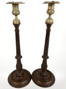 A pair of George III turned mahogany candlesticks with brass sockets, height 40 cm.