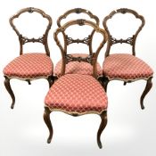 A set of four Victorian carved walnut salon chairs