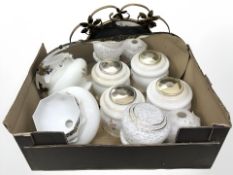 An Art Deco frameless mirror, a further brass framed mirror, assorted light shades.