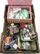 A wicker sewing box, assorted spools of thread, buttons, similar items.