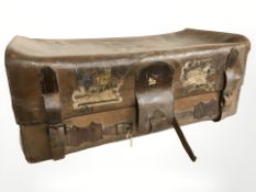 An early 20th century brown leather trunk labelled 'WM.