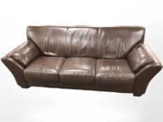 A contemporary stitched leather two seater settee,
