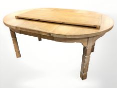 A Danish blond oak extending dining table with two leaves,