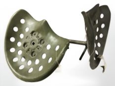 Two painted metal tractor style seats.