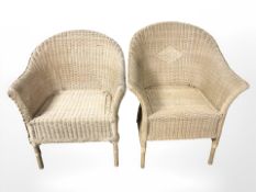 A pair of wicker armchairs.