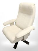 A late 20th century Danish swivel armchair in oatmeal fabric.