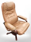 A Danish tan leather swivel lounge armchair