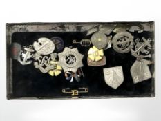 A tin containing boys brigade and other badges and pins.