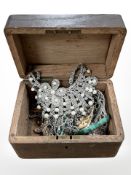 An antique wooden box containing costume jewellery