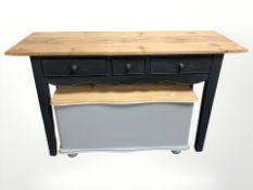 A painted pine three drawer side table, width 126 cm, and a pine blanket box.
