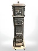 A 19th century cast iron stove, 157 cm x 44 cm x 44 cm.