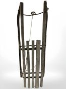 An early 20th century child's sledge, length 89 cm.