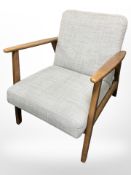 A contemporary Danish beech armchair with grey upholstery,