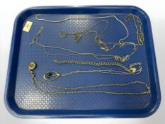 A group of silver and white metal chains, pendant on chain, etc.