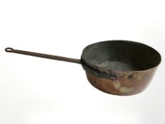 A Victorian brass long handled pan and three further graduated examples.