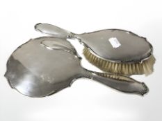 A silver mounted dressing table hand mirror and brush, Birmingham marks, longest 27.5 cm.
