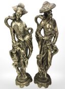 A pair of brass effect Eastern resin figures, height 49 cm.