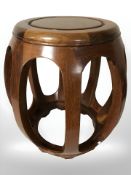 A contemporary Chinese hardwood barrel seat,