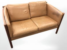 A late 20th century Danish wood framed tan leather two seater settee, length 141 cm.