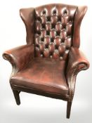 A 20th century Oxblood leather Chesterfield wingback armchair,