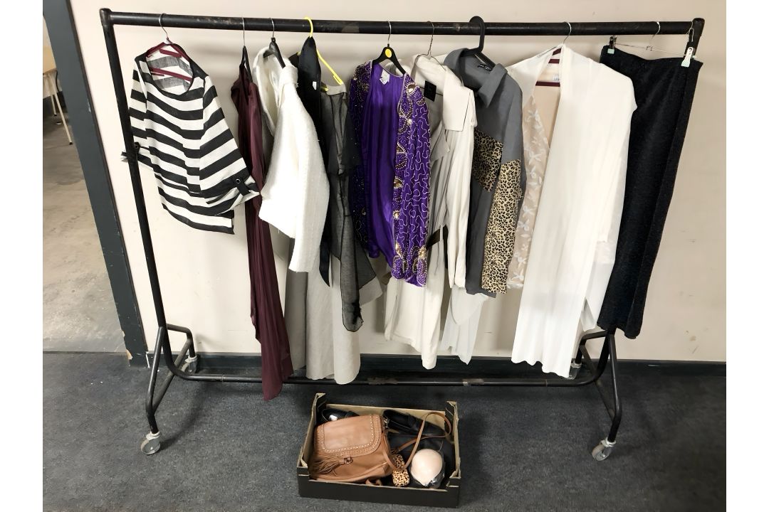 A rail of lady's clothing, leather hand bags, etc. - Image 1 of 2