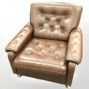 A late 20th century Danish button brown leather armchair on chrome feet,