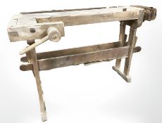 An early 20th century pine workbench fitted with two vices, length 131 cm.