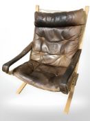 A 20th century Danish bentwood and tan buttoned leather lounge chair.
