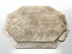 A Robert 'Mouseman' Thompson of Kilburn hexagonal oak bread board, with carved mouse signature,