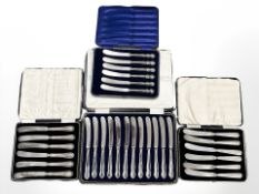 Three boxed sets of six silver-handled knives and a further set of twelve.
