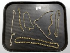 A group of gold plated and yellow metal chains, pocket watch chain.