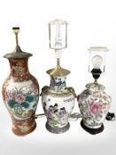 Three 20th century oriental earthenware lamp bases, tallest 63 cm including fitting.