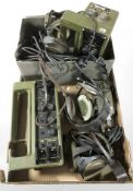 A group of vintage military radios, headsets, etc.