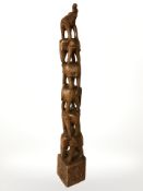 A carved hardwood pillar depicting elephants,