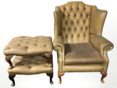 A 20th century Chesterfield buttoned tan leather wingback armchair, and two similar footstools.