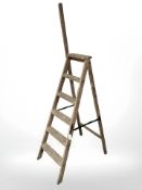 An early 20th century folding pine step ladder