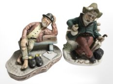 Two ceramic figures of seated tramps.