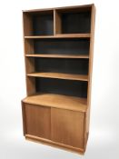 A 20th century Danish teak open bookcase with sliding cabinet door beneath, 100 cm x 41 cm x 199 cm.