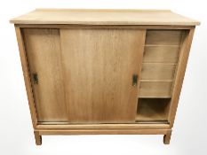 A Danish oak sliding door side cabinet, 109 cm x 46 cm x 97 cm.