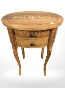 A reproduction inlaid hardwood oval bedside table, fitted two drawers, width 45 cm.
